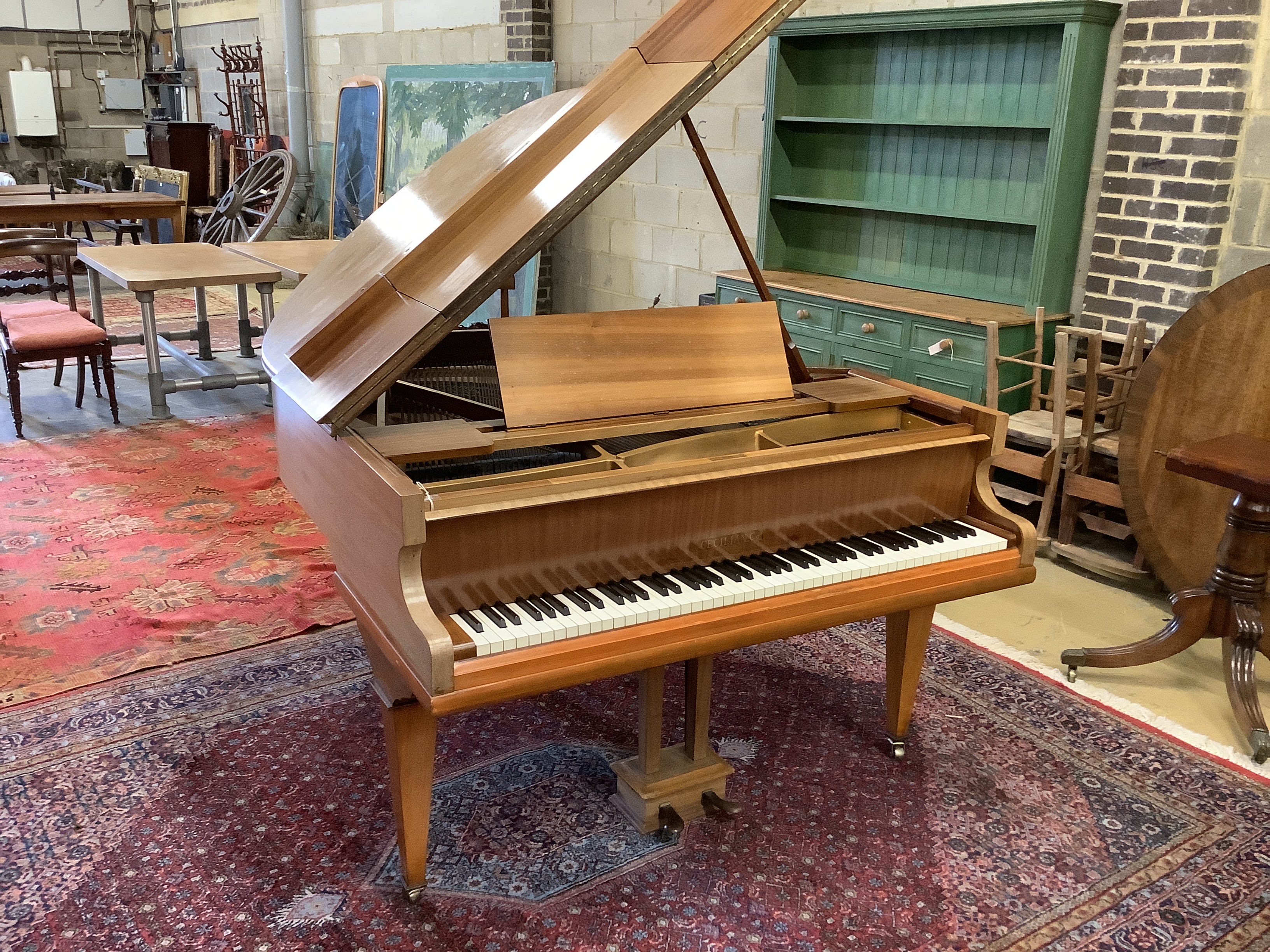 A mid 20th Cecilian & Co mahogany baby grand piano retailed by Harrods Ltd